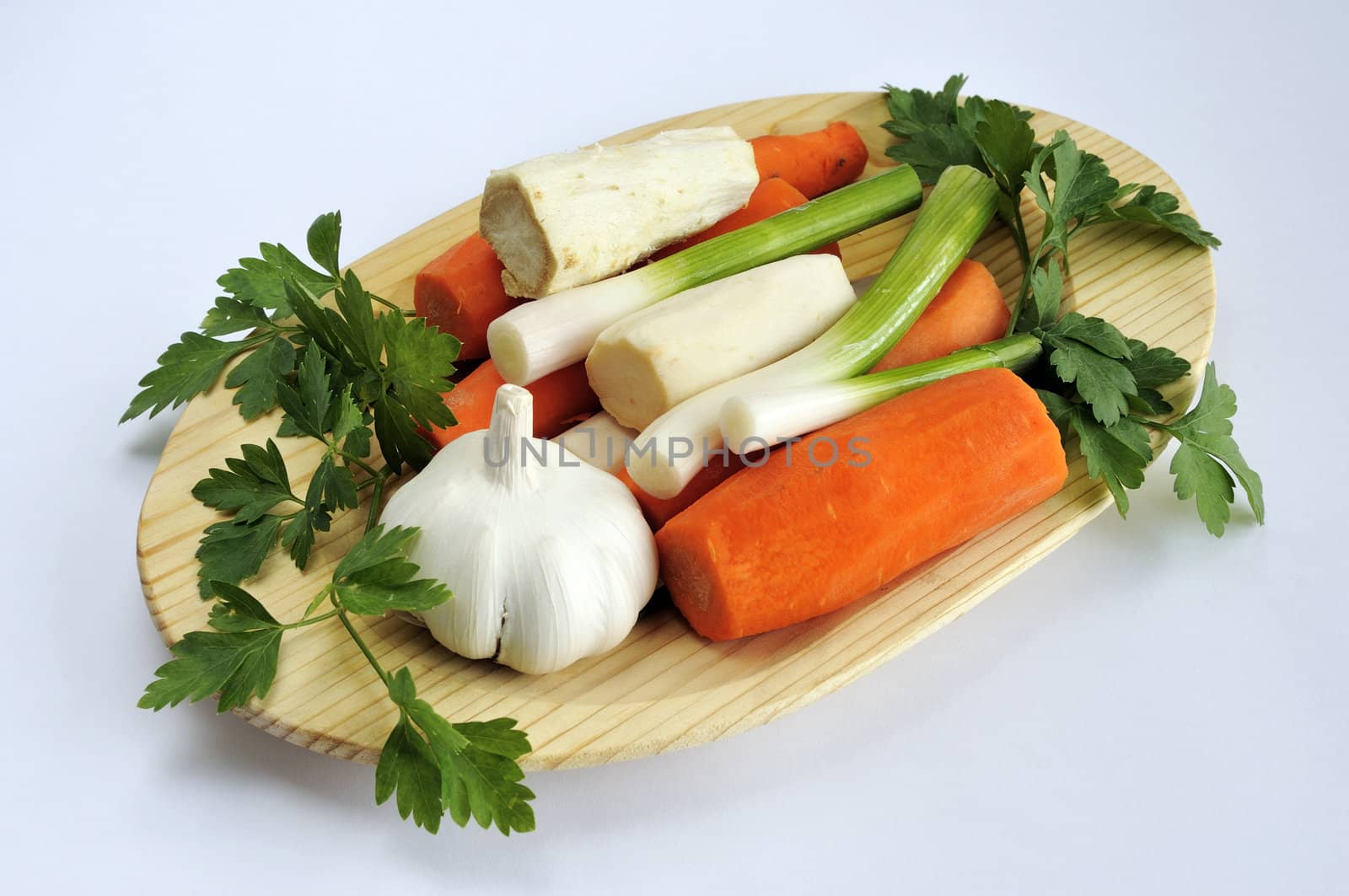 Assorted vegetables on a wooden plate 