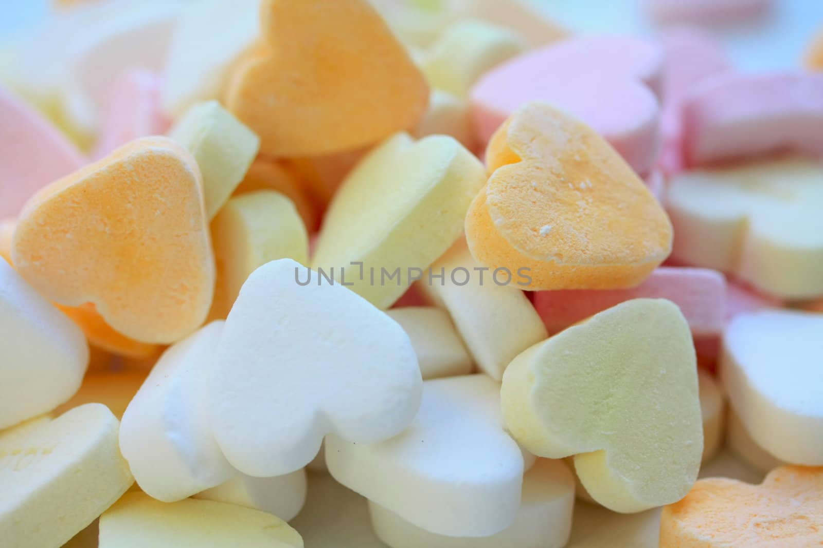 Pile of valentine candy hearts in sweet colors