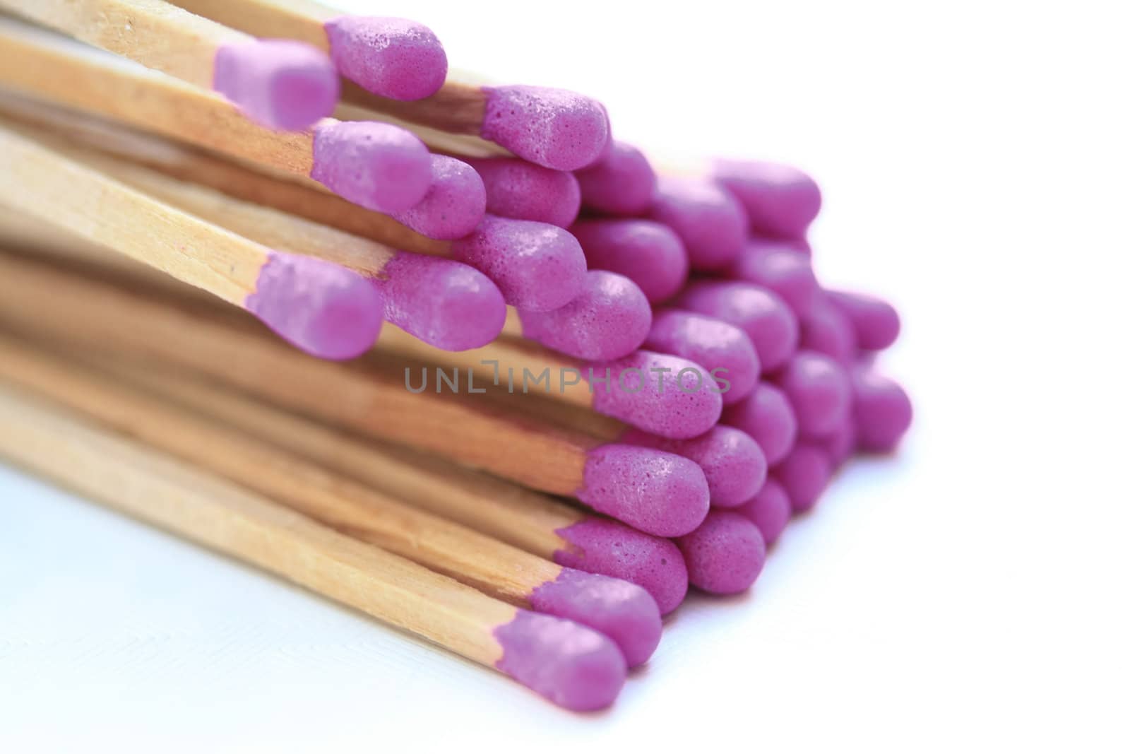 A pile of matches with purple tips