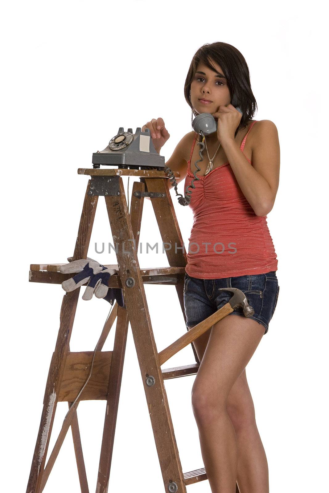teenage girl standing on ladder talking on a old rotary phone with 