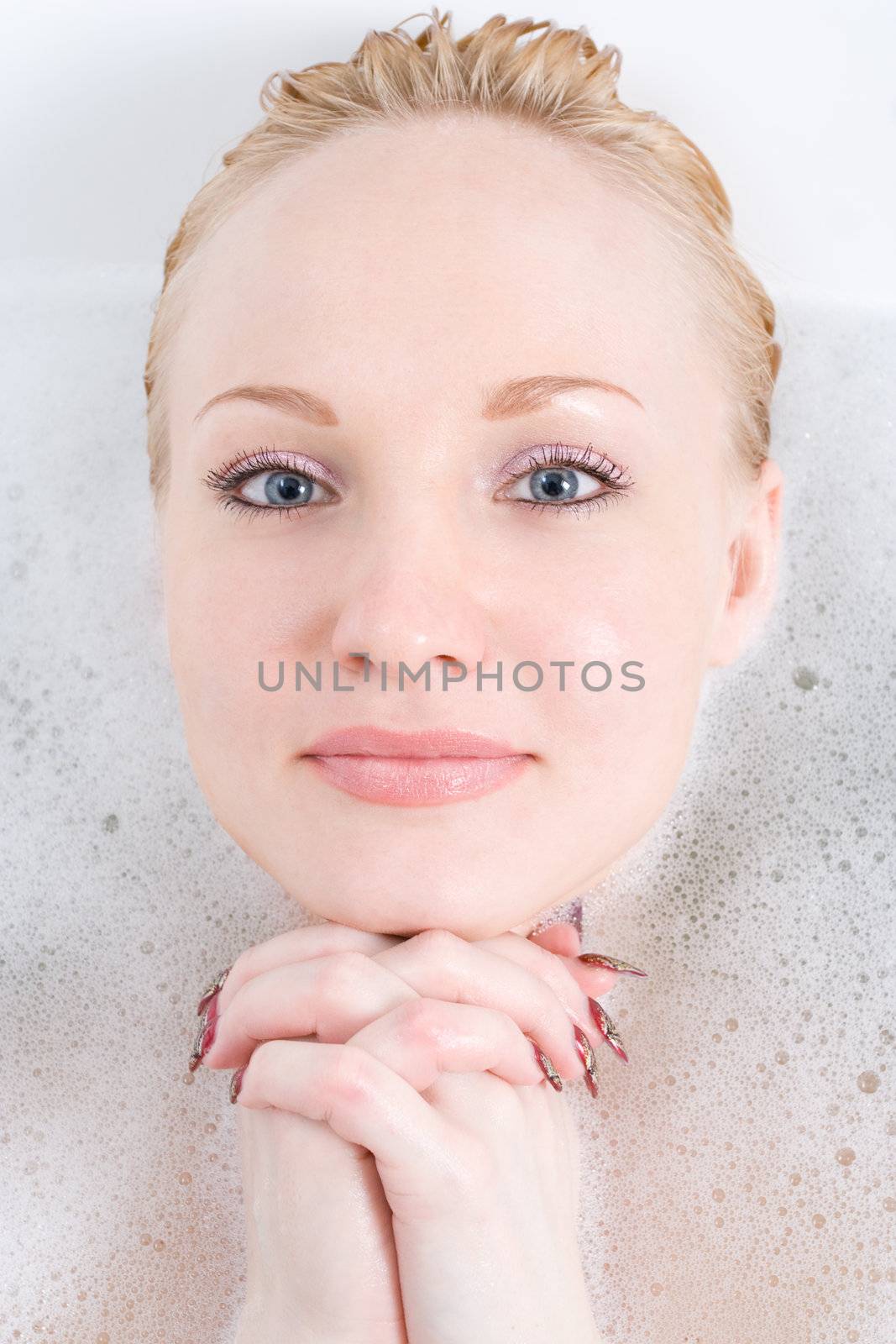 a hand and head of young woman to put out from foam water