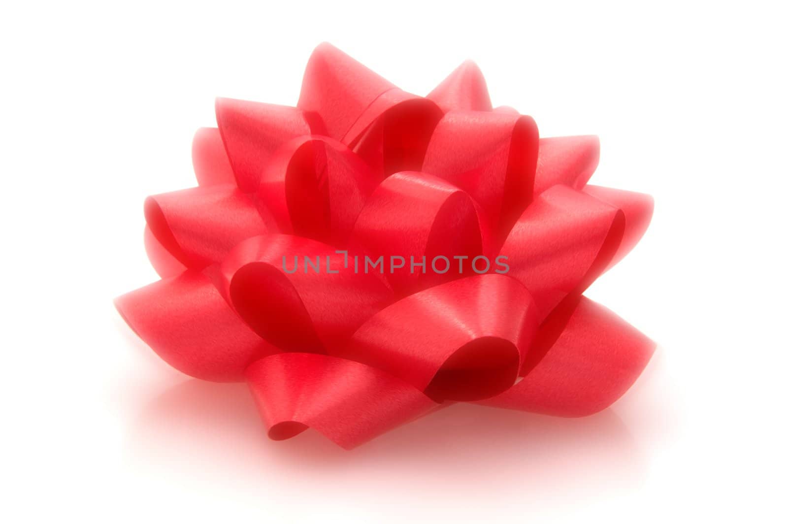 Red bow with a dreamy quality isolated on white