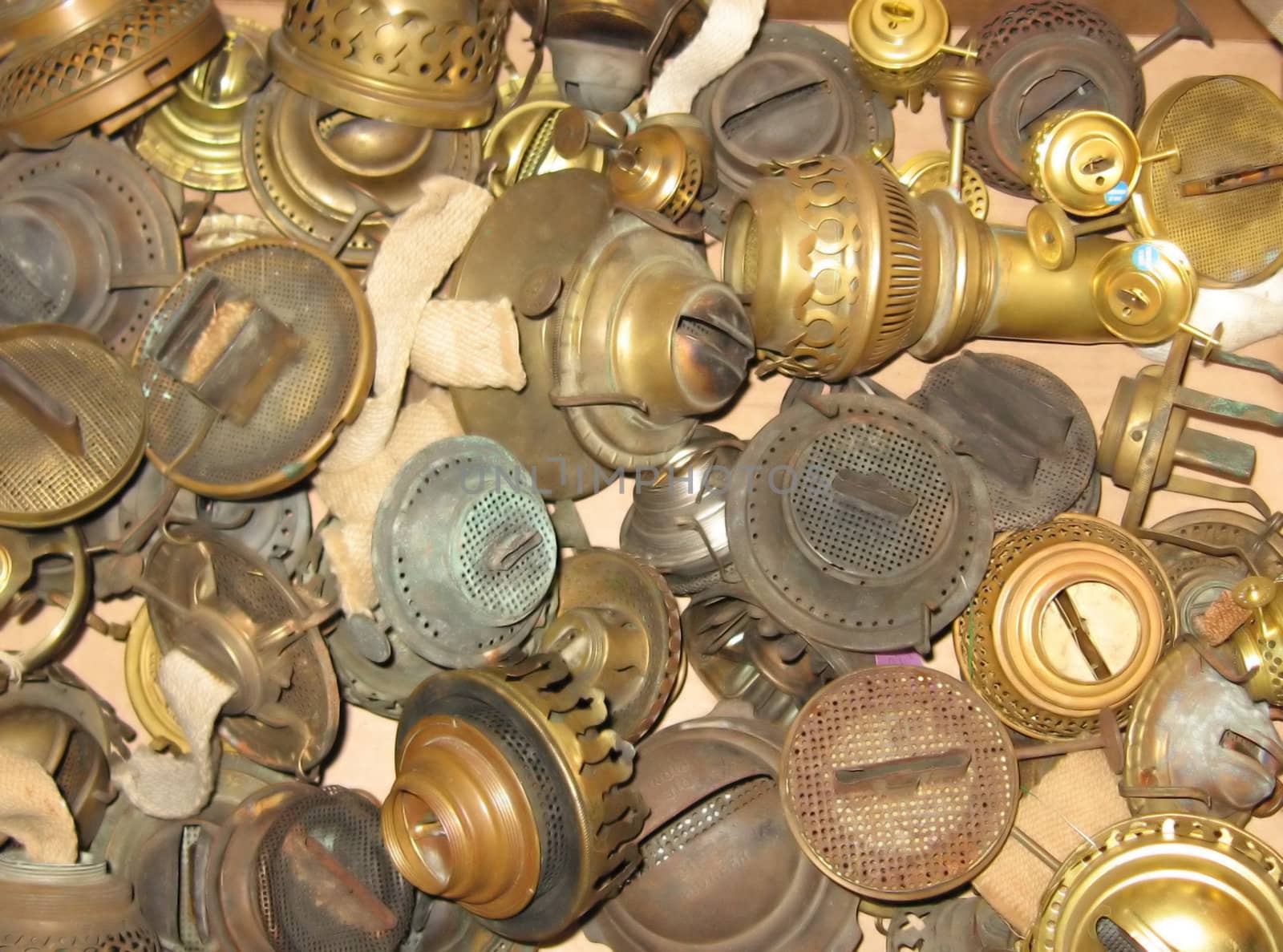 a grouping of antique lamp parts, made of brass, more than 100 years old
