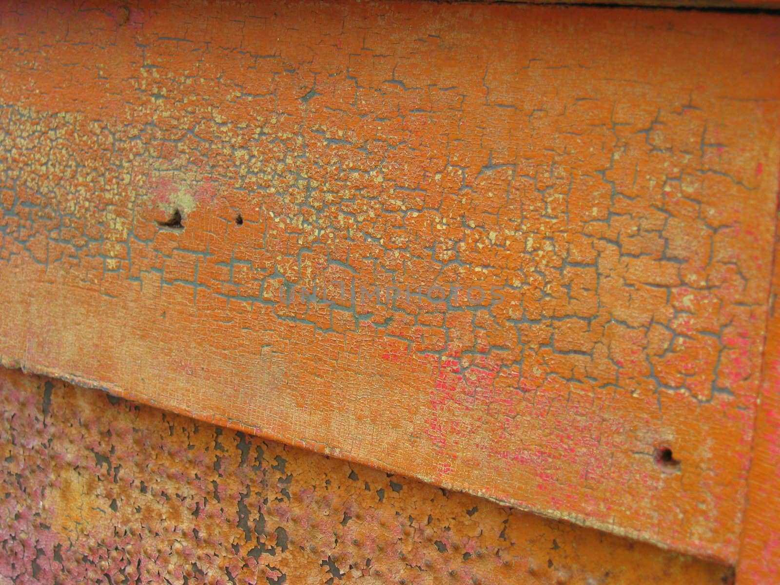 Old pumpkin-colored paint over old blue paint, showing crackling texture from antique age 