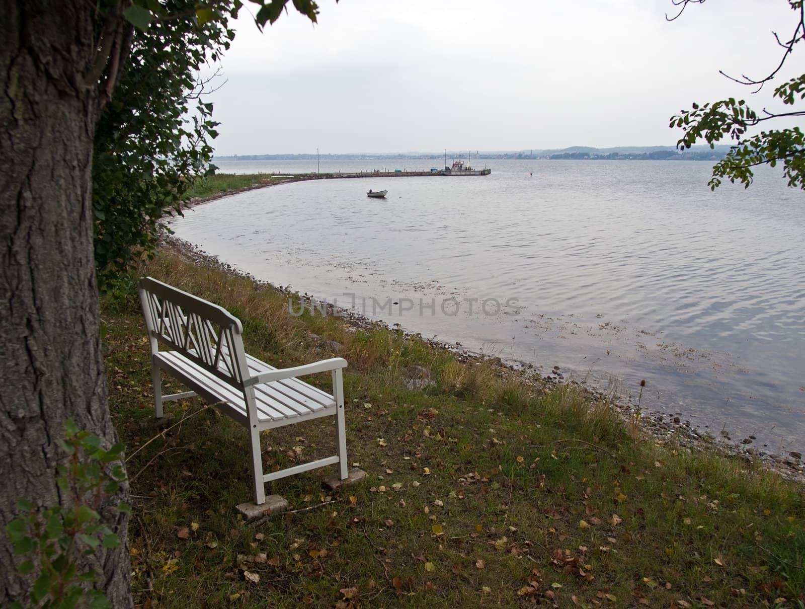 Beautiful white wooden bench with a viewpoint looking out to sea