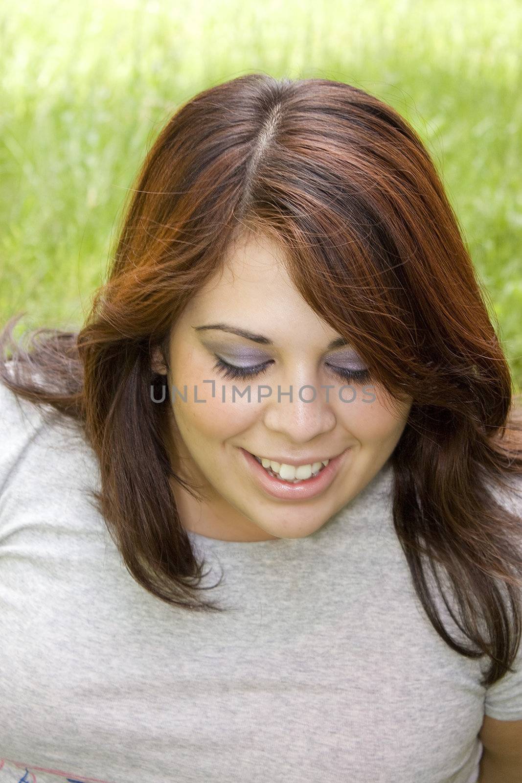A cute Puerto Rican girl in her early twenties with red highlights in her hair.