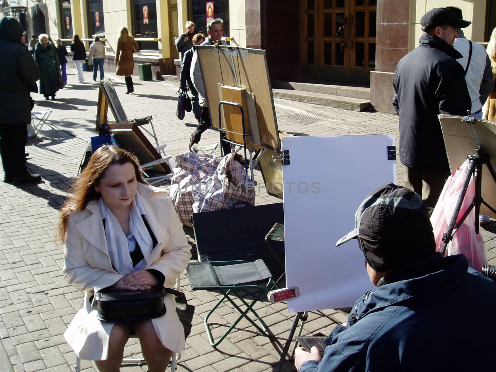 The Arbat, Moscow, Russia. The Artists draw the portraits a passer-by.