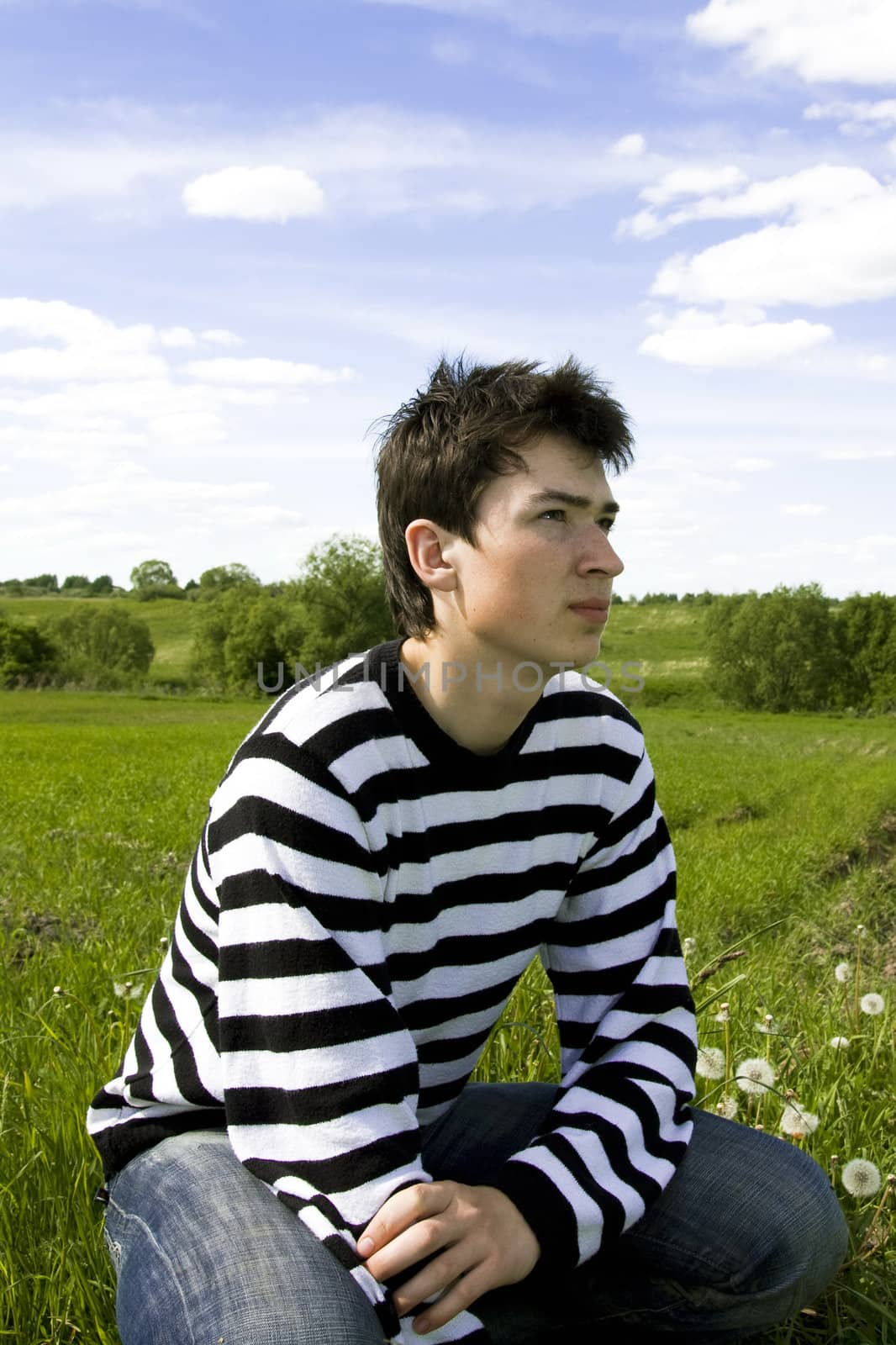 Portrait of the young guy on nature background