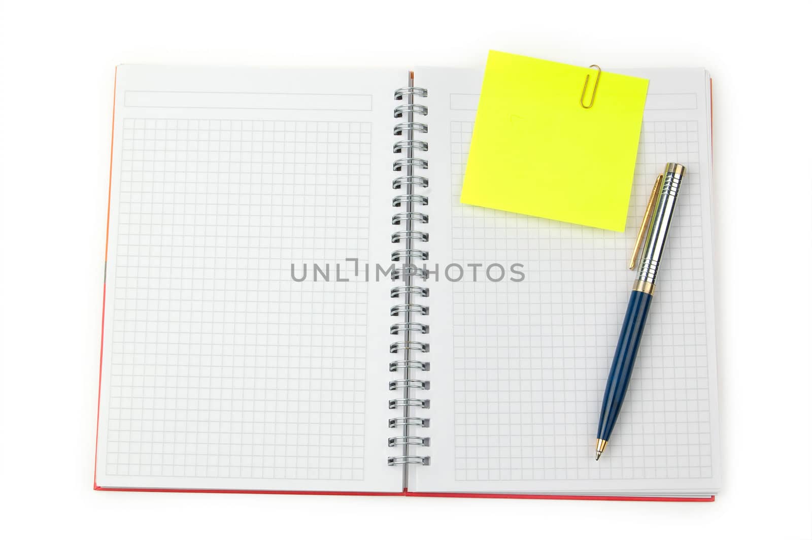 Yellow adhesive note and pen on a notebook. White background.