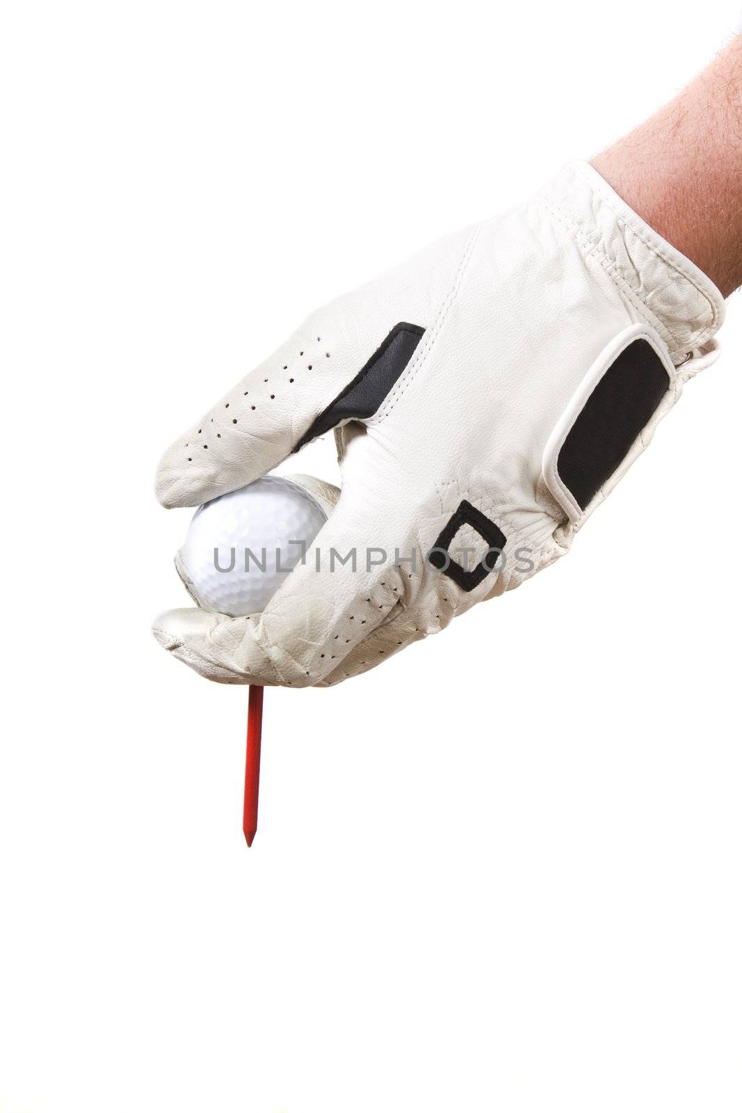 Isolated glove hand setting a golf ball