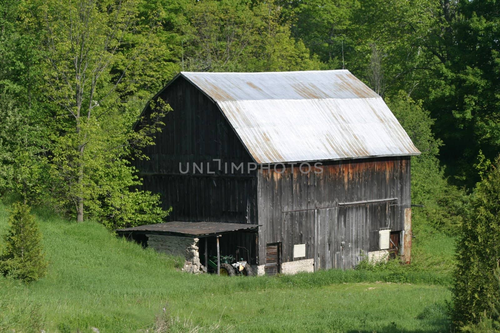 Weathered barn in green valley by jodygary97
