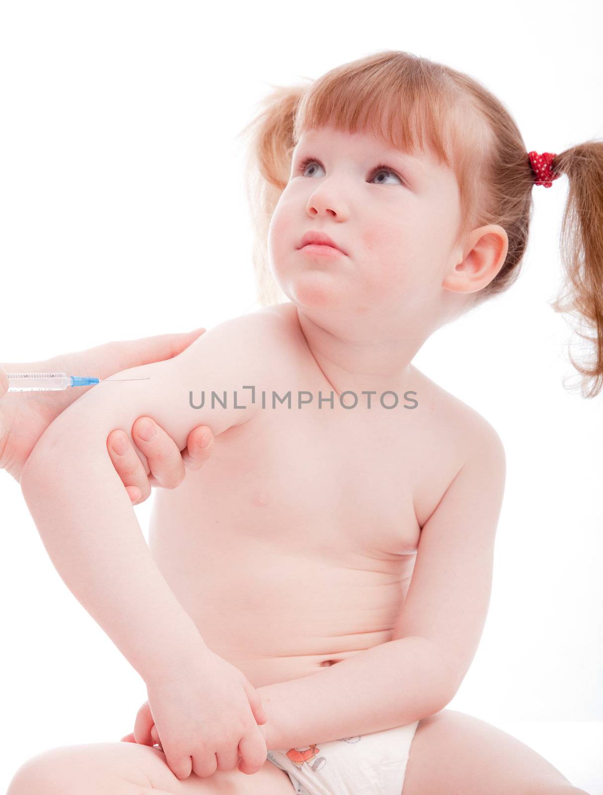 Little caucasian girl in a hospital. Vaccination procedure.