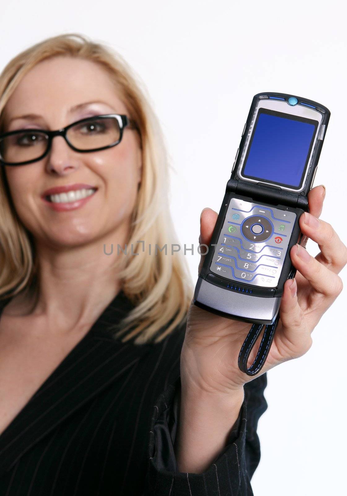 A cheerful woman holding an open flip style mobile phone