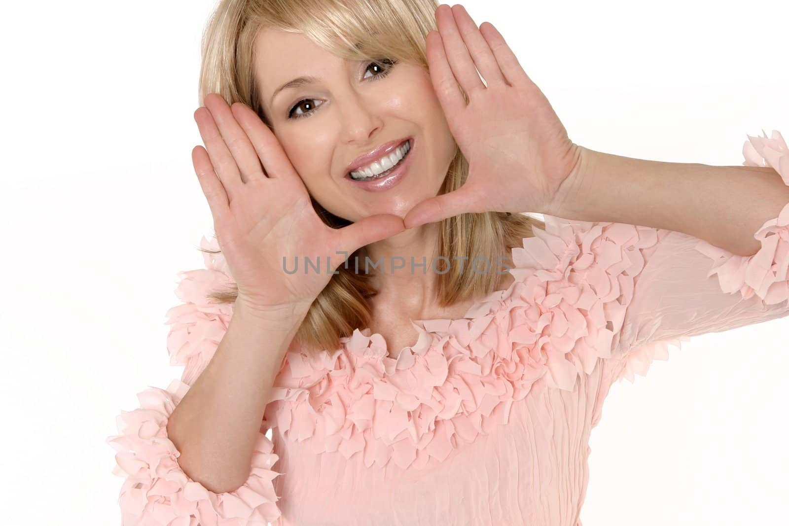A woman frames her face with palms