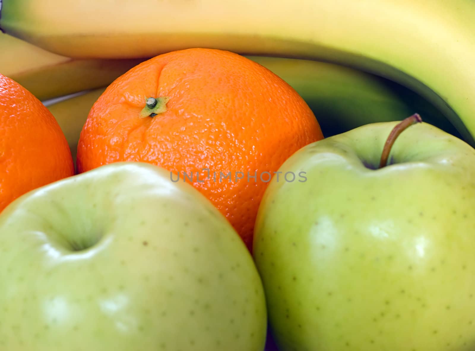 A background made of assorted fruit including apples, oranges and bananas