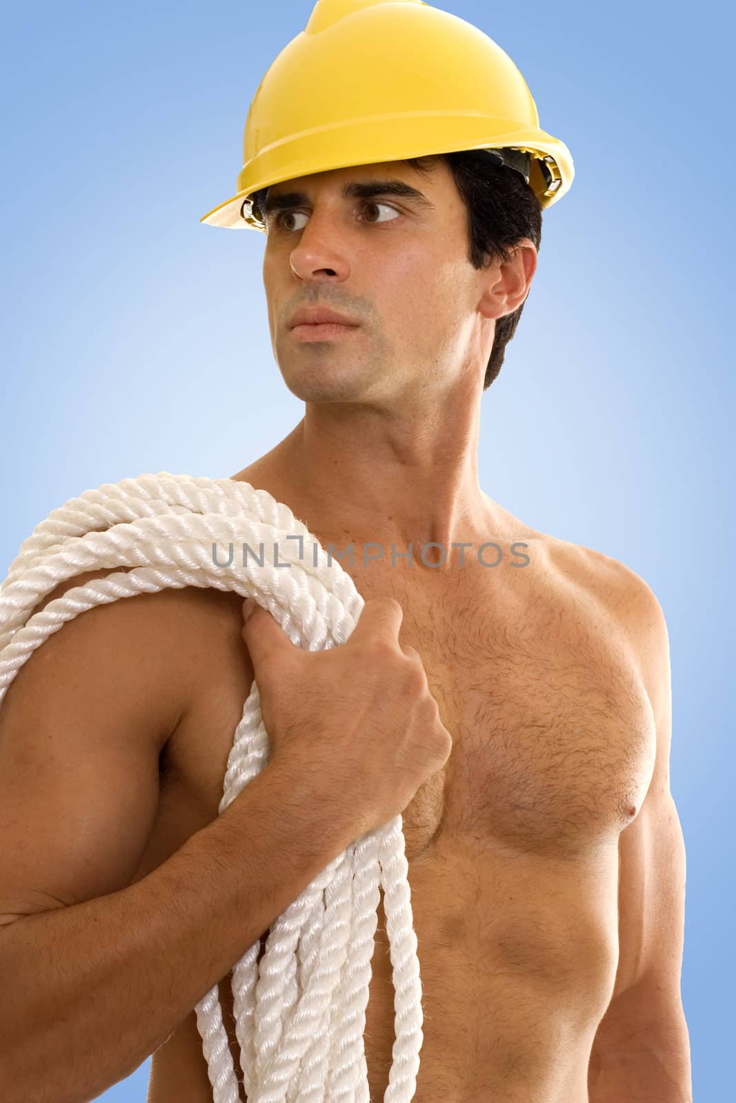 Builder wearing hard hat and carrying srope