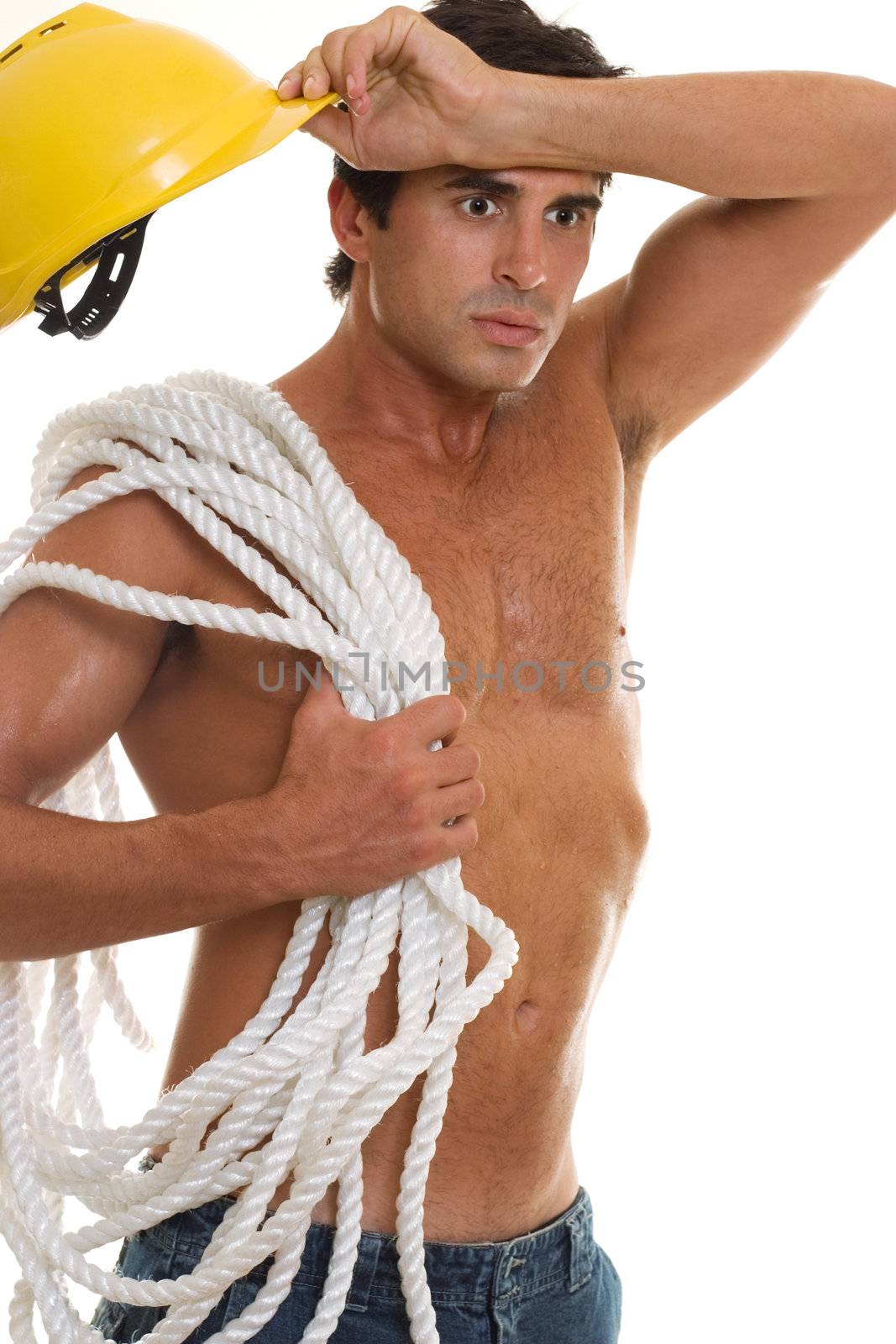 Hot and tired builder wipes sweat from his brow.