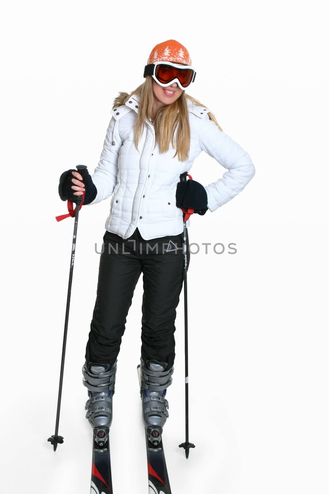 Smiling female wearing ski gear and equipment.