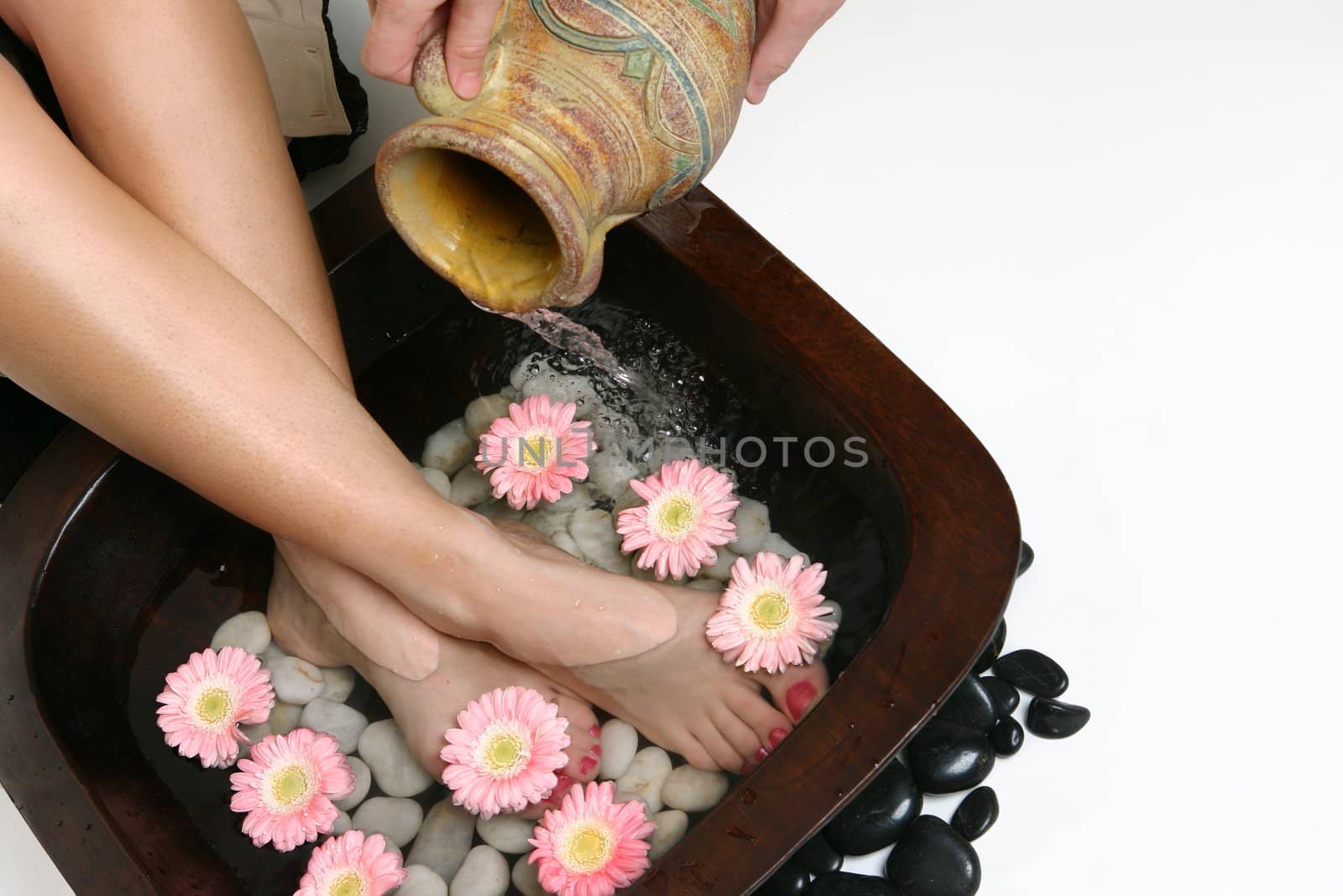 Warm water is poured into a footbath.  Space for copy