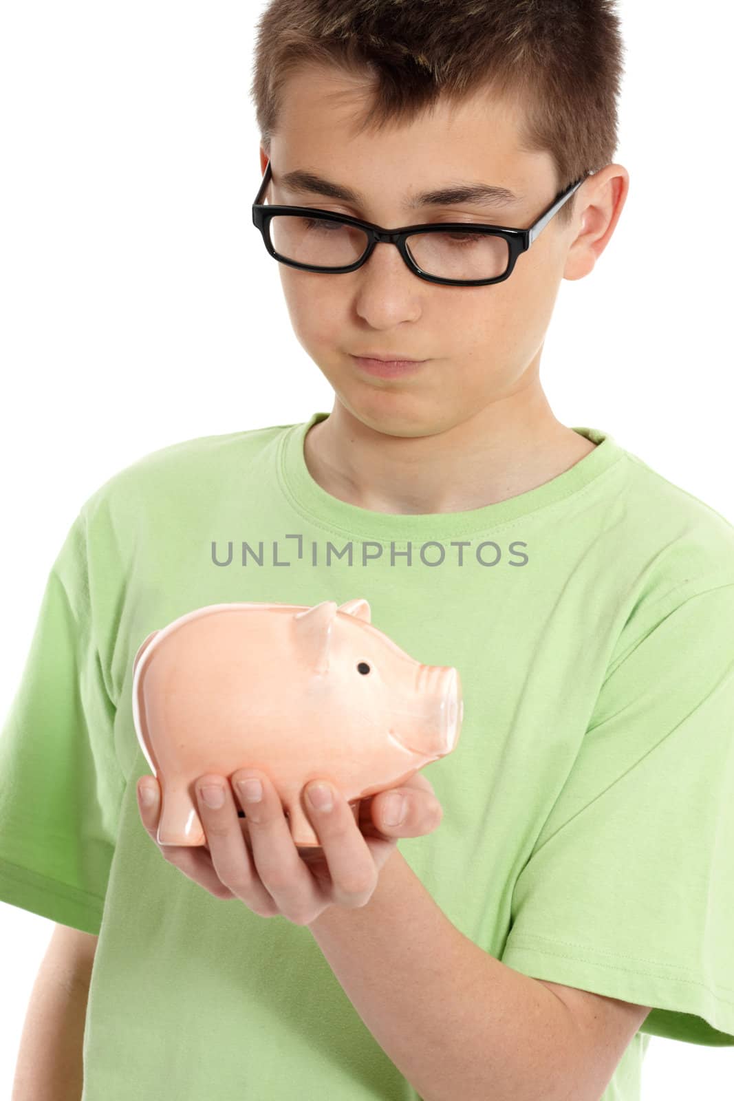 Boy wearing a green t-shirt ponders over a money box.