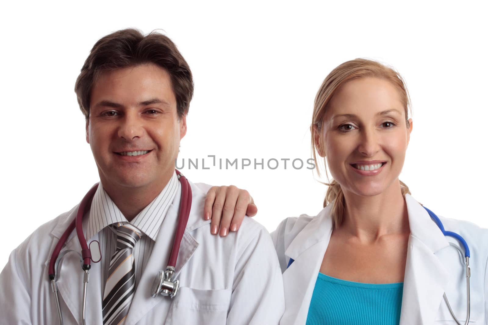 Medical healthcare professionals in uniform stand casually together with relaxed friendly smiles.