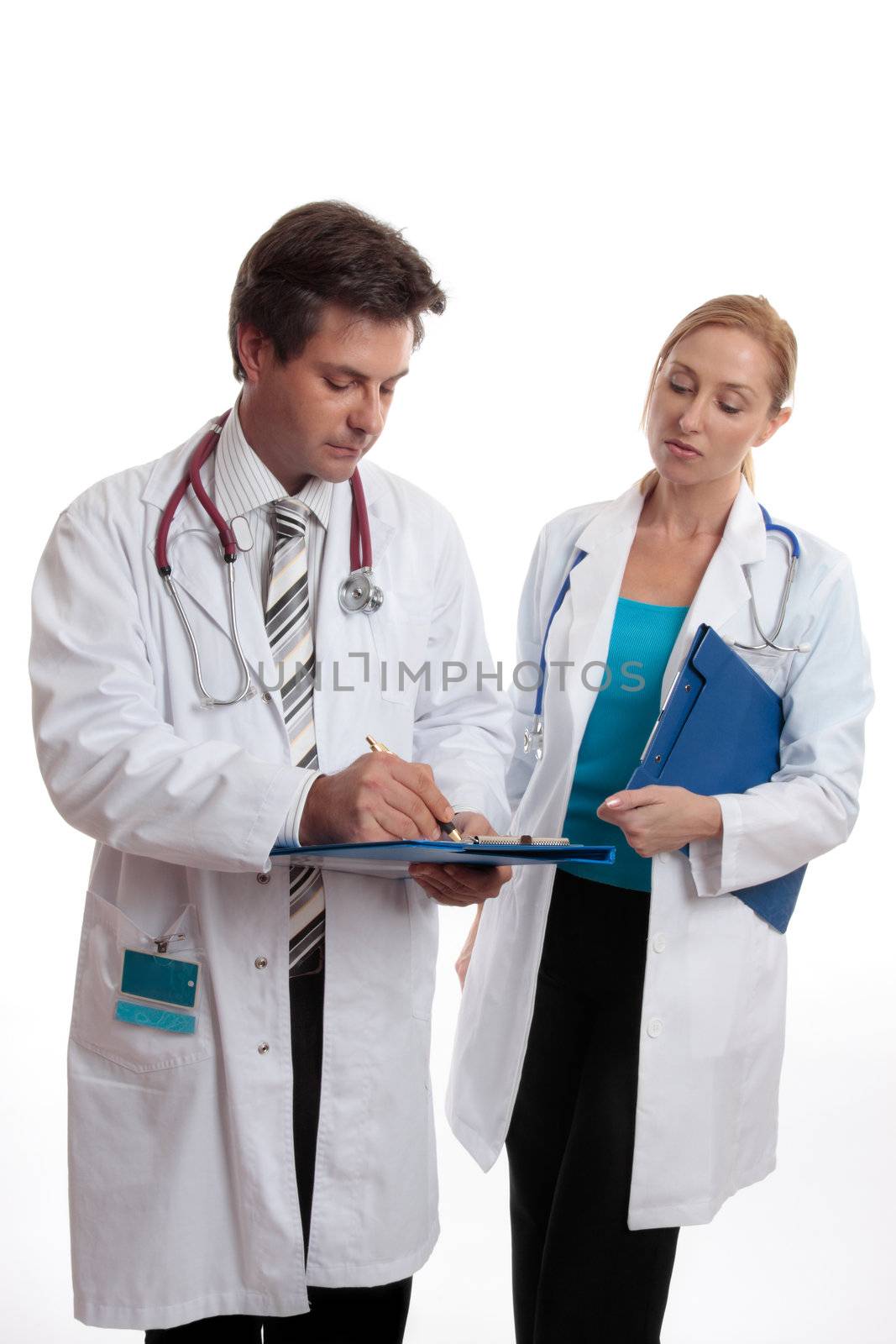 Two doctors discuss a patients medical ailment or treatment.