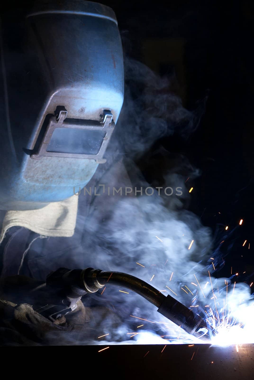 a welder working at shipyard at night