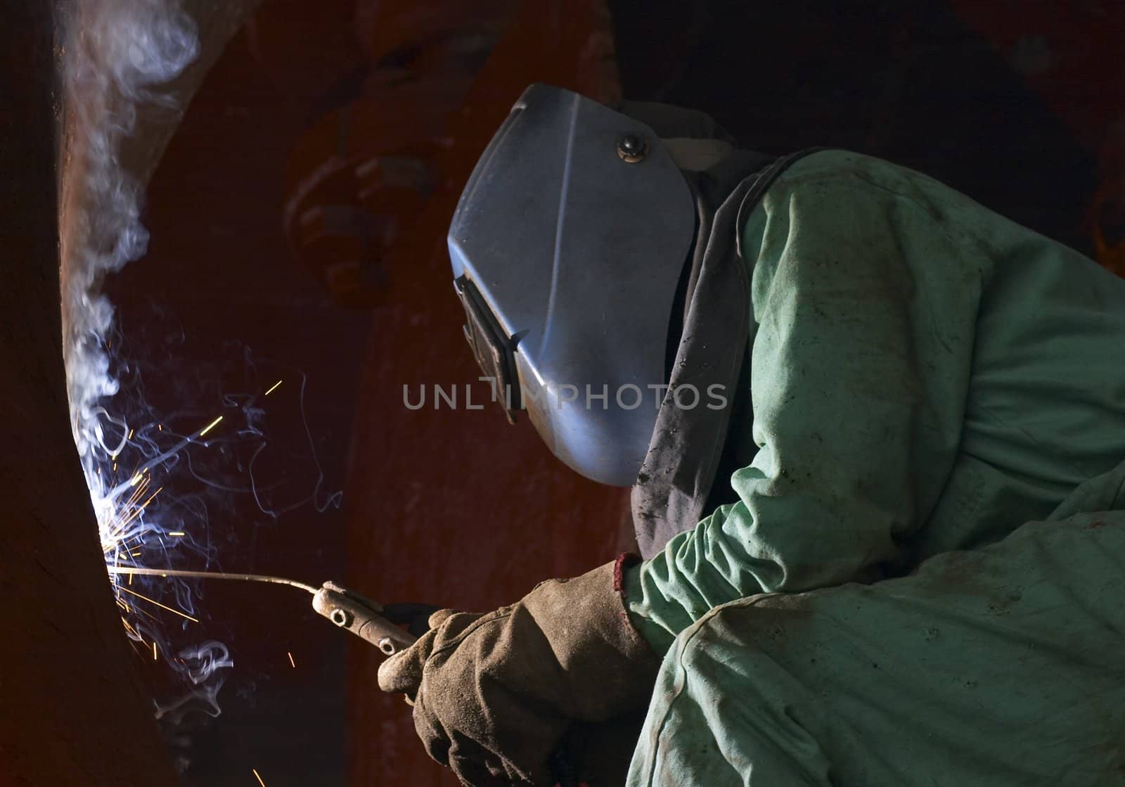 a welder working at shipyard at night