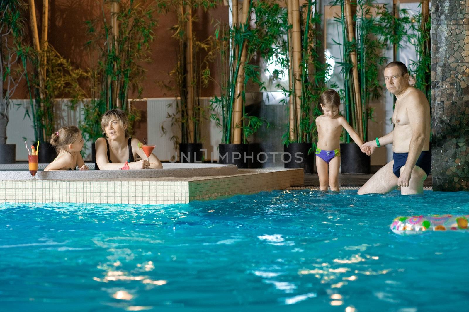 Family in swimming-pool by fotorobs