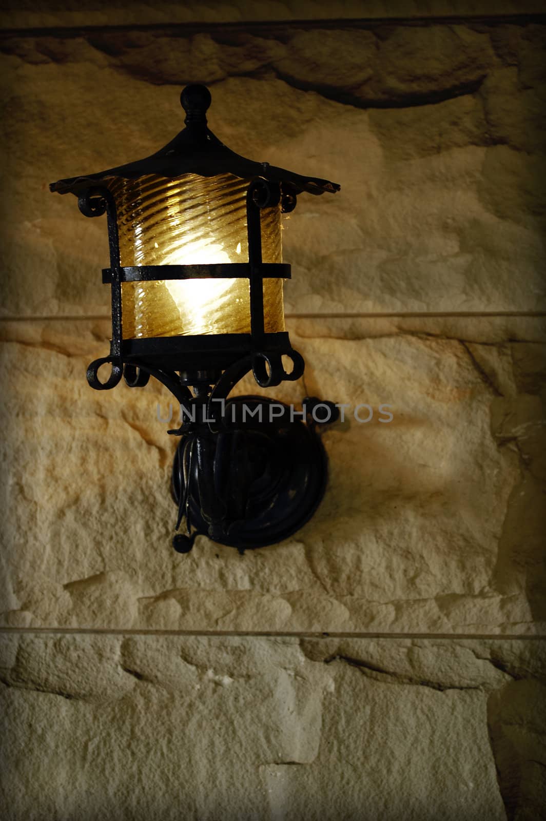 antique sconce on old brick exterior wall