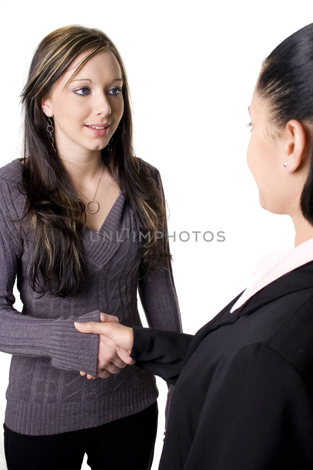 Young woman in interview shaking hands