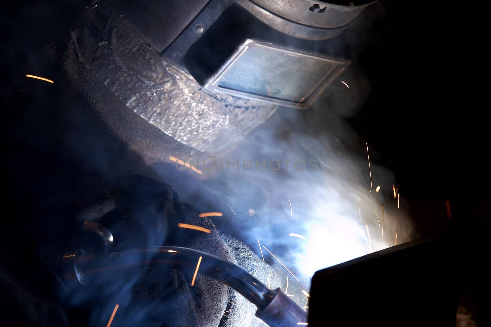 a welder working at shipyard at night