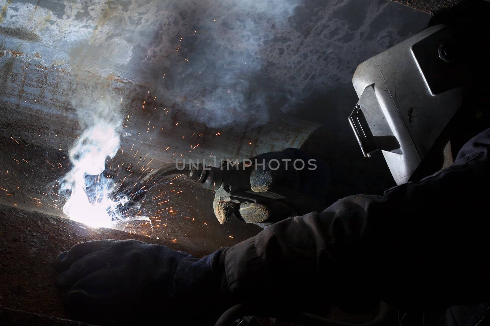 a welder working at shipyard during night shift