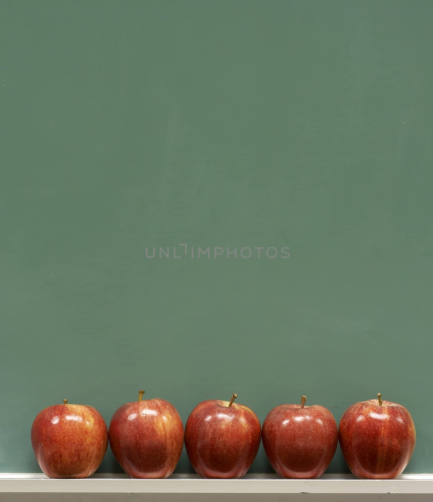 red apples on chalkboard in school classroom