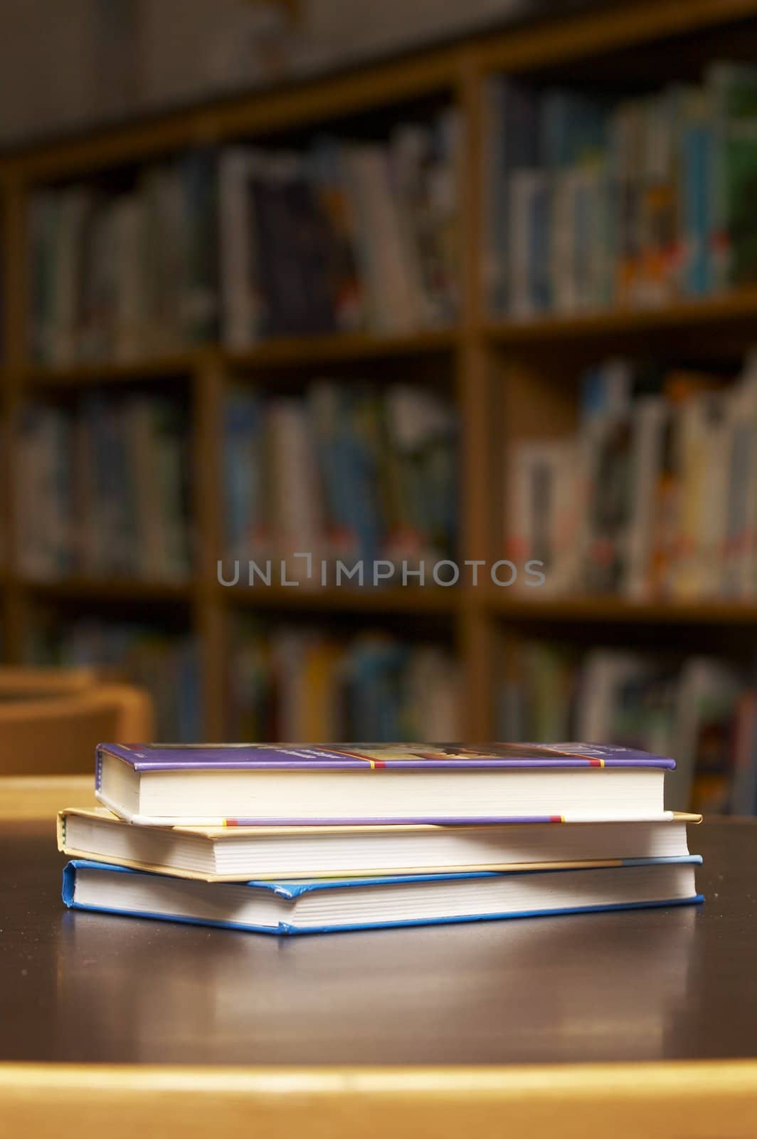 three books stacked on a table