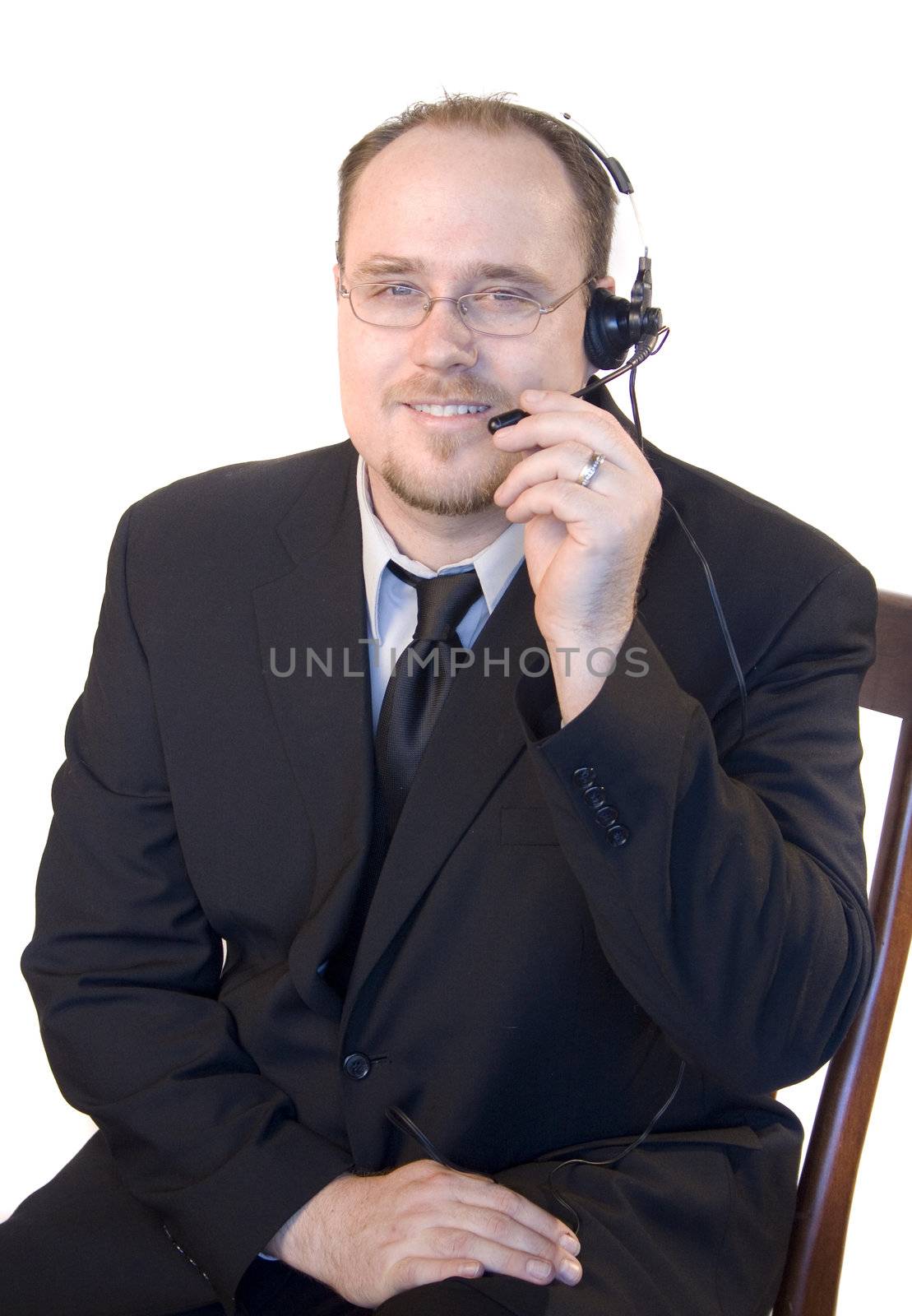 Young business man with headset talking on phone