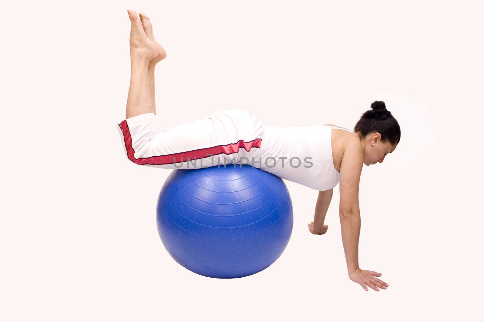 Woman doing exercises with pilates ball