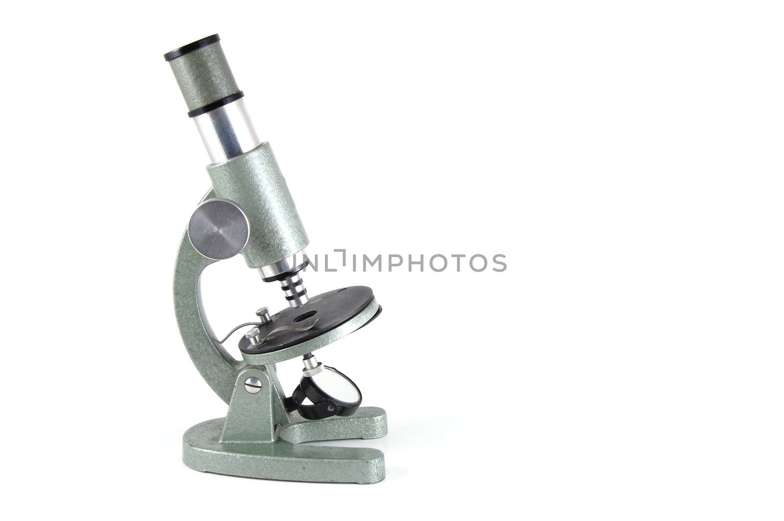 Old microscope isolated on a white background