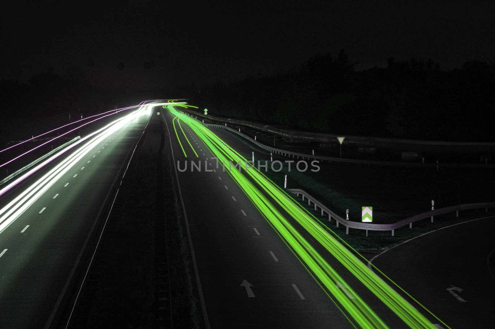 road with car traffic at night and blurry lights showing speed and motion