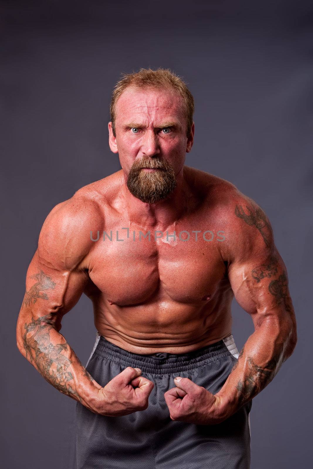 Middle aged man body builder by phakimata