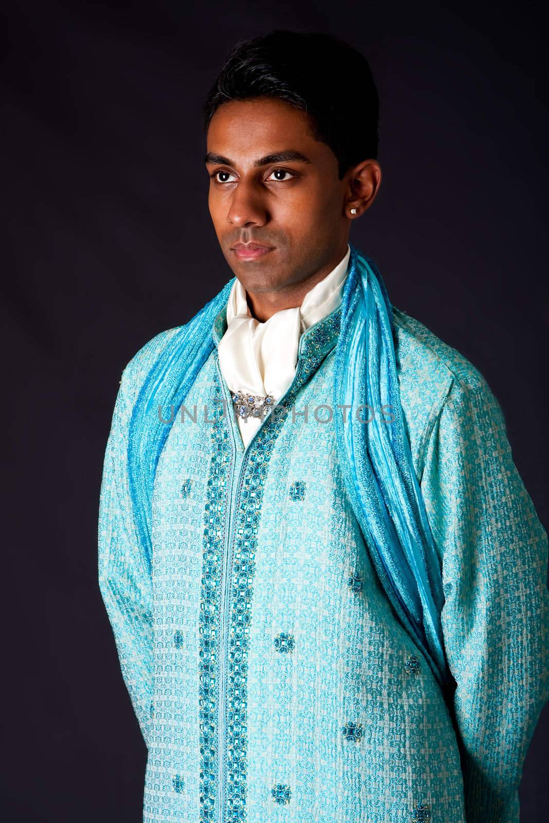 Beautiful authentic Indian hindu man in typical ethnic groom attire. Bangali male wearing a light blue agua decorated Dhoti with shawl.