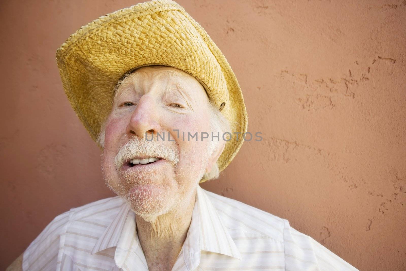 Senior Citizen Man with a Funny Expression Wearing a Straw Cowboy Hat