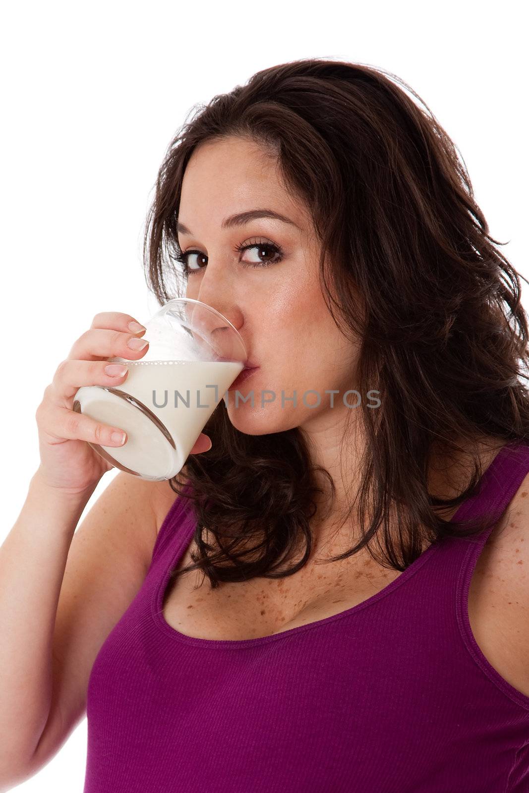 Beatiful face of a Caucasian Hispanic Latina female brunette woman drinking milk, isolated. Milk is a great source of vitamine D and Calcium and promotes bone health fighting osteoporosis.