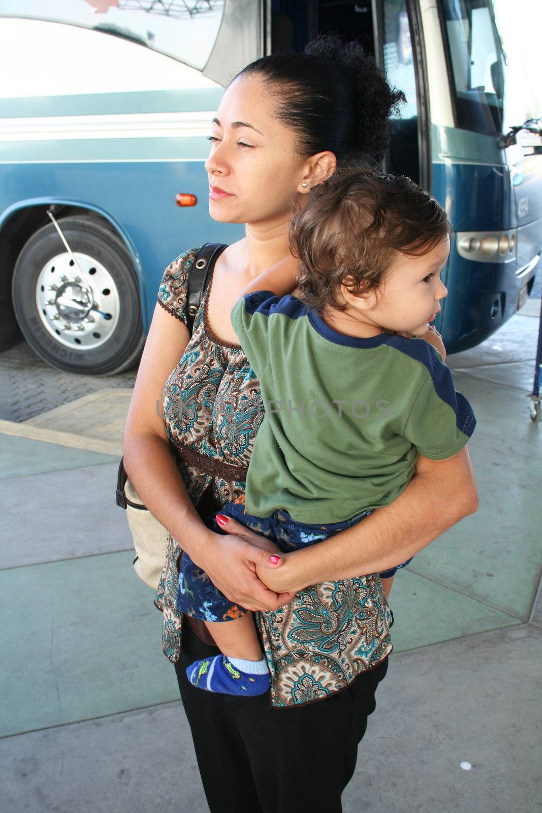 mother and child waiting at bus terminal