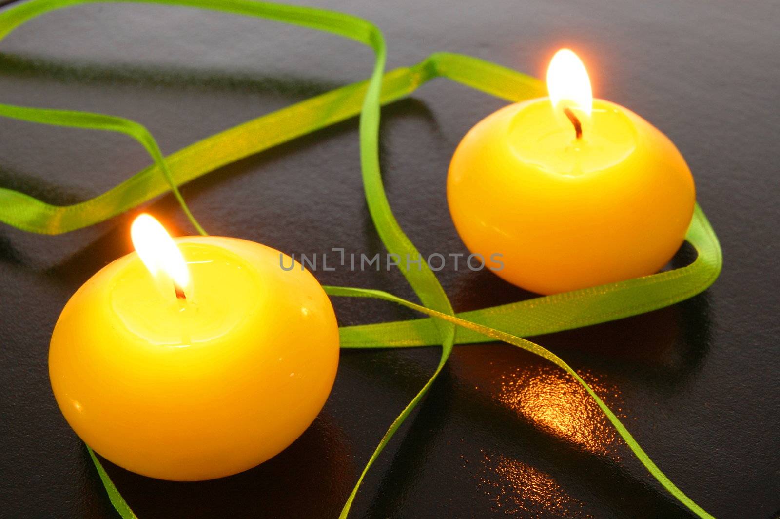 yellow candles showing spa or welllness concept