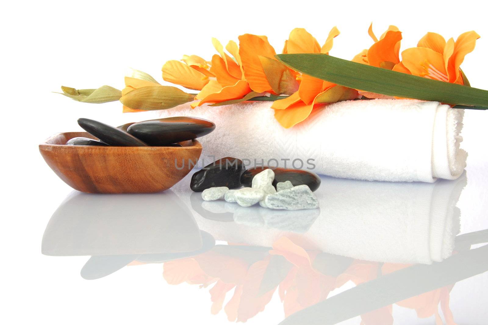 wellness zen and spa still life with flower towel and pebbles isolated on white