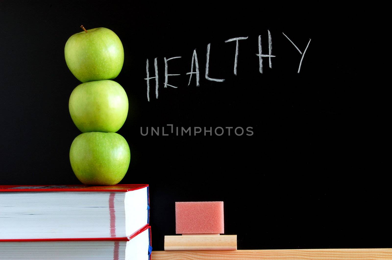 apples books and chalkboard showing healthy lifestyle