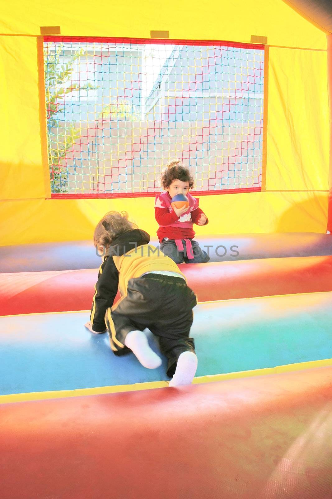 kids playing in inflatable air castle