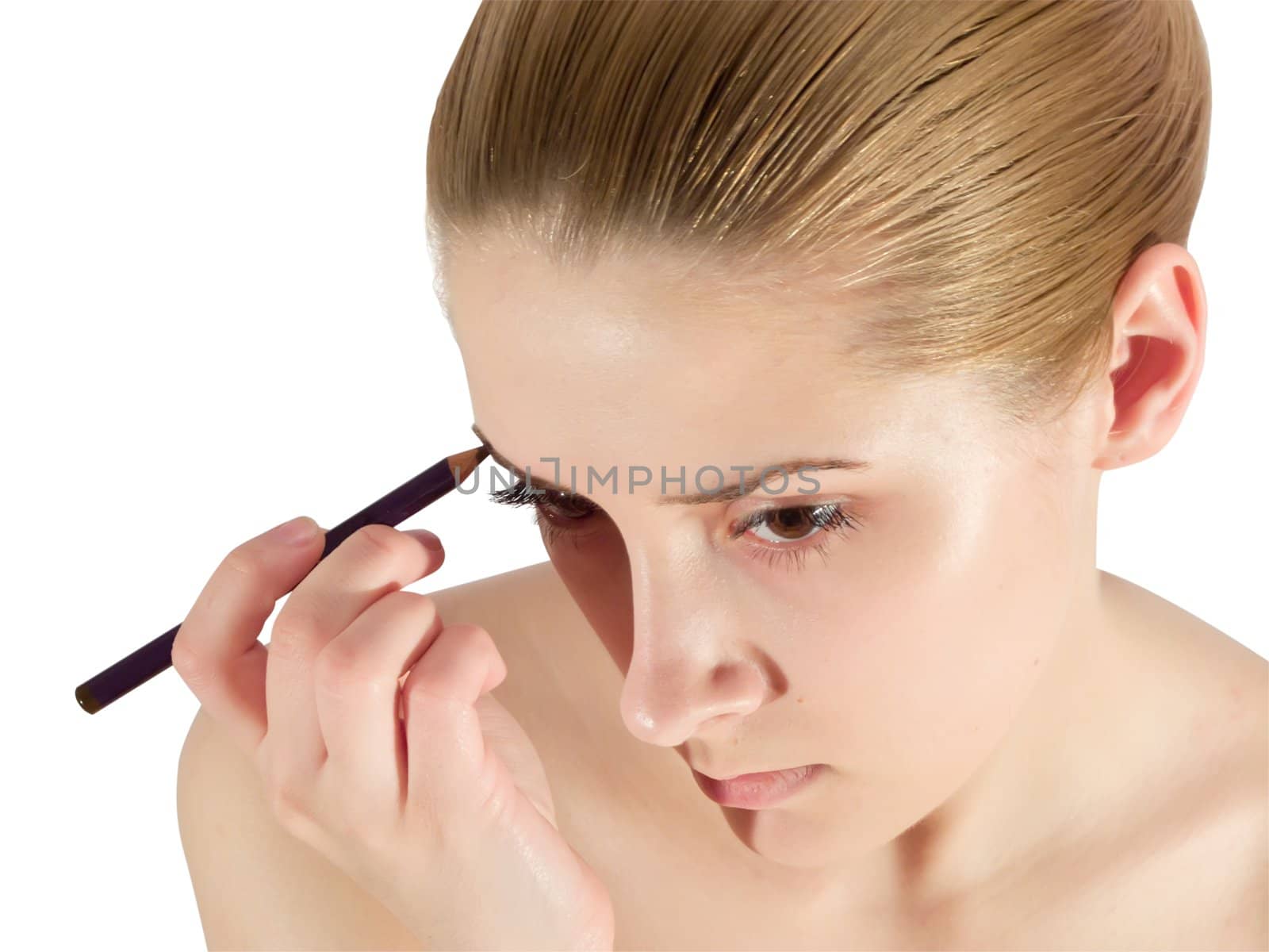 young woman putting make up on her face. Isolated