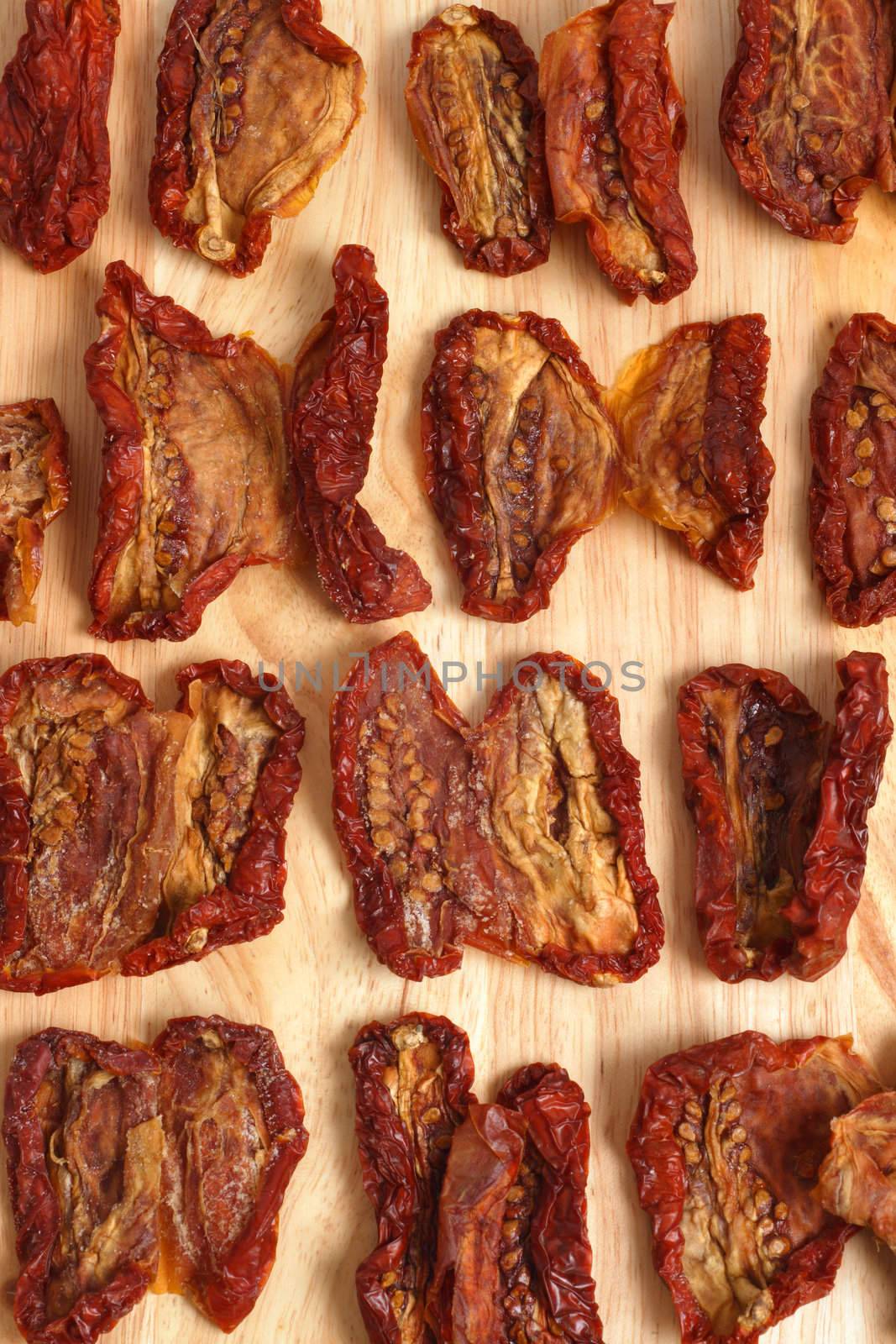A background image of sun-dried tomatoes on a wooden board.
